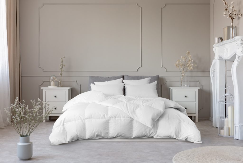European white goose down comforter and pillows on a pretty bed. 
