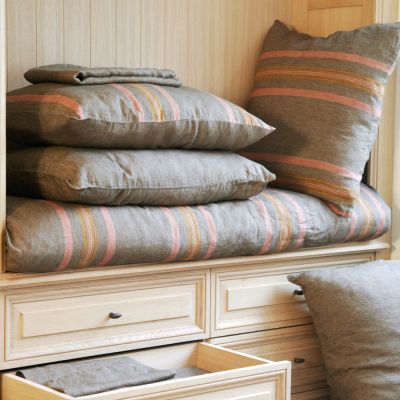 Nottinghill solid brown sheeting shown with the red and mustard striped duvet cover & shams